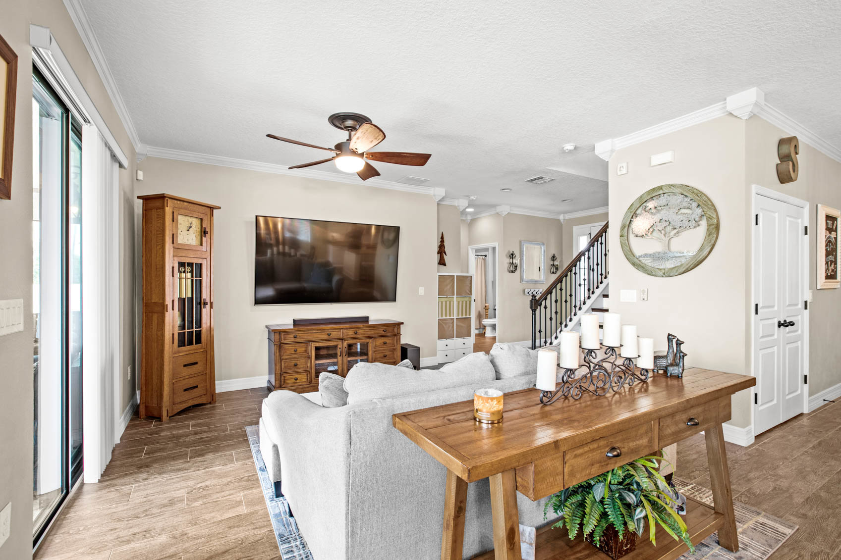 living room with grey sectional and stairs